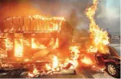  ?? AP/PTI ?? Flames consume a car and building as the Camp Fire tears through Paradise, California