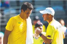 ??  ?? Bernard Tomic (left) and Lleyton Hewitt during Australia’s 2016 Davis Cup campaign.
