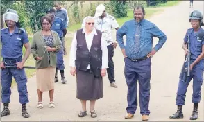  ?? ?? The school’s management with police officers during a petition delivery by SNAT members yesterday.