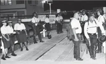  ??  ?? Police ranks as they lined the bridge leading to the Mon Repos Primary School