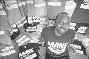  ?? PHOTOS BY MIKE BROWN/THE COMMERCIAL APPEAL ?? Elliott Sayles, at his home and distributi­on center in East Memphis, began his line of “mane” T-shirts with prayer and a $200 investment. The shirt references the pronunciat­ion of “man” that is commonly associated with the Bluff City.