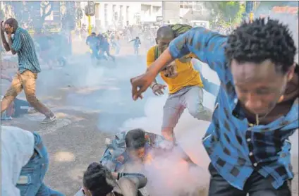  ??  ?? Cost of free education: Police fire stun grenades during the #FeesMustFa­ll protests (above). Students Shaeera Kalla and Nompendulo Mkatshwa (below) were leaders of the movement. Photos: Daylin Paul