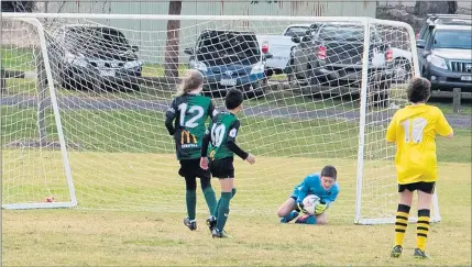  ??  ?? SAVE: Stawell Pioneers juniors Danikah Harman, left, and Aiden Guerrero watch team-mate goal keeper Max Smethurst take control of the ball. Picture: TARAKAY