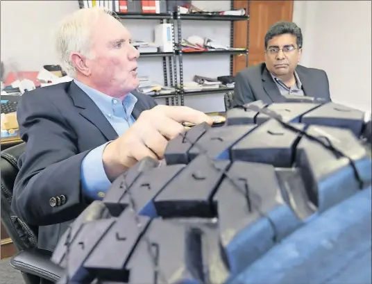  ?? MASTURZO/AKRON BEACON JOURNAL] [PHIL ?? Dr. Jon Gerhardt, left, and Abraham Pannikottu, both of American Engineerin­g Group, talk about their design of a run-flat tire for the military.