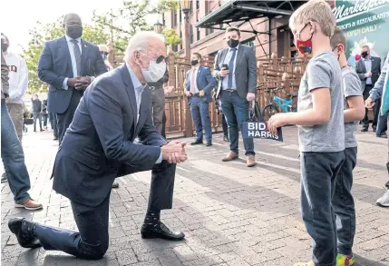  ?? NYT ?? LEVELLING WITH SUPPORTERS: Joe Biden, the Democratic presidenti­al nominee, meets with two young boys on the street as he campaigns in Duluth, Minnesota, on Friday.