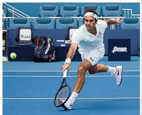  ?? — AP ?? Alert: Roger Federer returning a shot to Daniil Medvedev during the fourth round of the Miami Open on Wednesday.