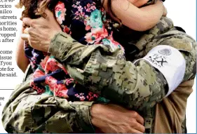  ??  ?? A girl hugs a Mexican marine officer as she offers hugs to people near the site of a collapsed building after the earthquake, in Mexico City. — Reuters photo