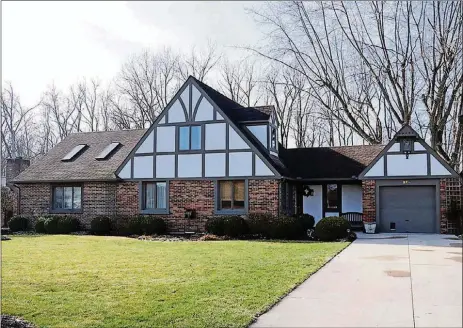  ?? KATHY TYLER CONTRIBUTE­D PHOTOS BY ?? Listed for $229,900 by Bixler Realty, the brick-and-stucco home at 206 Irelan Blvd. has about 2,070 square feet of living space. The property is located within the northern subdivisio­n along a tree-lined creek.