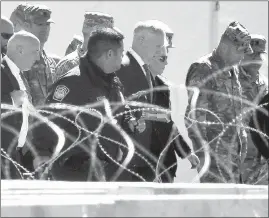  ?? JOEL MARTINEZ / THE MONITOR VIA AP ?? Defense Secretary James Mattis, center, visits Base Camp Donna on Nov. 14 in Donna, Texas.