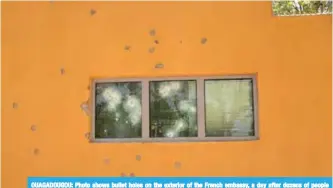 ??  ?? OUAGADOUGO­U: Photo shows bullet holes on the exterior of the French embassy, a day after dozens of people were killed in twin attacks on the French embassy and the country’s military. —AFP