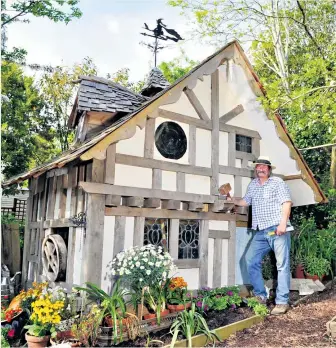  ??  ?? One man and his shed: Brian poses next to his latest Hansel-and- Gretel style creation