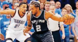  ?? [PHOTO BY NATE BILLINGS, THE OKLAHOMAN] ?? San Antonio’s Kawhi Leonard, right, is defended by Oklahoma City’s Andre Roberson on May 12, 2016. Leonard has told the Spurs that he would like to be traded this summer, according to a person familiar with the situation.