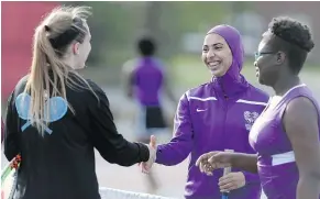  ??  ?? Deering High School’s Tabarek Kadhim, centre, congratula­tes an opponent after a tennis match in Windham, Maine.