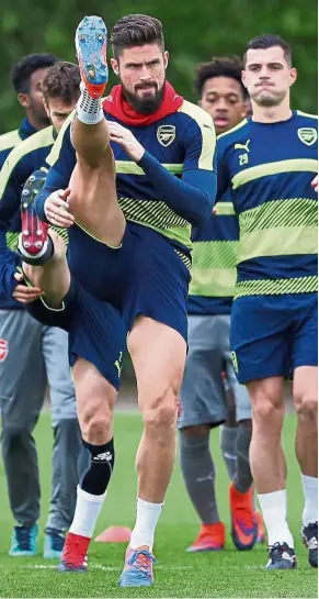  ?? — AP ?? Fighting for a starting place: Olivier Giroud stretches during Arsenal’s training session in London yesterday. Arsenal face Paris St Germain in the Champions League Group A match today.