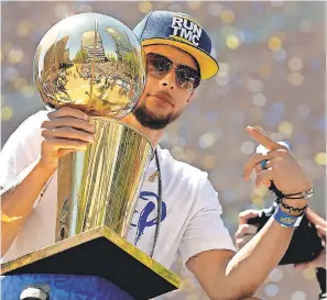  ?? CARY EDMONDSON/USA TODAY SPORTS ?? Steph Curry holds onto the Larry O’Brien trophy during this year’s victory parade, the Warriors’ third in four seasons.