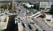  ?? DRONEBASE VIA AP ?? This photo provided by DroneBase shows the collapsed pedestrian bridge at Florida Internatio­nal University in the Miami area on Thursday, March 15, 2018.