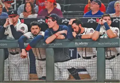  ?? AP PHOTO/JOHN BAZEMORE ?? The Atlanta Braves watch from the dugout in the ninth inning of their 5-4 loss to Colorado Rockies on Tuesday in Atlanta.