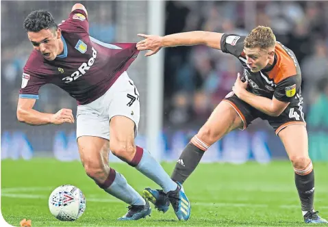  ??  ?? John Mcginn in recent action against Brentford’s fellow Scot Lewis Macleod