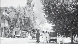  ?? THE ASSOCIATED PRESS ?? Smoke rises from a building after a deadly attack including a suspected suicide car bombing and gun battles, in Jalalabad, Afghanista­n, Tuesday. Nearly 20 people died and ore than 40 were hurt.