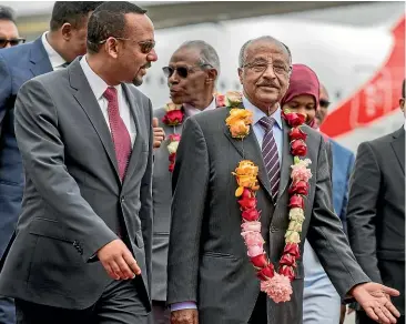  ?? AP ?? Eritrea’s Foreign Minister Osman Sale, right, is welcomed by Ethiopia’s Prime Minister Abiy Ahmed, left, upon the Eritrean delegation’s arrival in Addis Ababa yesterday.