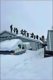  ?? Photo courtesy Cal Fire ?? Cal Fire crews shovel heavy, wet snow off a home’s roof in Mono County.