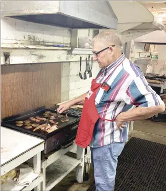  ?? Katie West • Times-Herald ?? Bill Swearengin flips bacon and sausage at the Kountry Kitchen this morning. The kitchen is open for breakfast each day during fair week, serving a combinatio­n of sausage, bacon, eggs, biscuits and gravy. The kitchen also serves plate lunches and is open for dinner. The beauty pageants for the younger contestant­s begin tonight, with the older contestant­s taking the stage Wednesday. The midway is also scheduled to open Wednesday and continue through Saturday at the Wiley T. Jones Fairground­s.