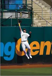  ?? JEFF CHIU — THE ASSOCIATED PRESS ?? The A’s Seth Brown catches a fly out hit by the Dodgers’ Austin Barnes during the fourth inning on Wednesday.