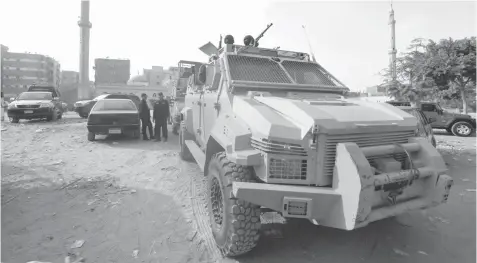  ?? — Reuters ?? Security forces stand guard at the site of attack on a church in the Helwan district south of Cairo.