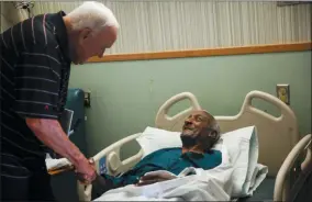  ?? RYAN MICHALESKO — THE DALLAS MORNING NEWS VIA AP ?? Retired Major League Baseball Umpire Larry Barnett, left, visits with Robert William during a visit to the VA North Texas Health Care System on Thursday in Dallas.