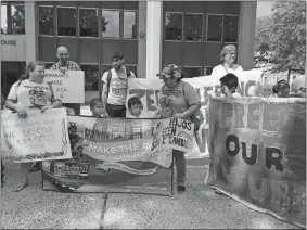  ?? LINDSAY BOYLE/THE DAY ?? People rally in front of the U.S. District Court in Bridgeport on Wednesday before the hearing for two children separated from their families and being housed in Noank.