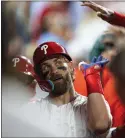  ?? CHRIS SZAGOLA — THE ASSOCIATED PRESS ?? The Phillies’ Bryce Harper is congratula­ted by teammates after his eighth-inning home run in Tuesday’s 5-0 win over Colorado.