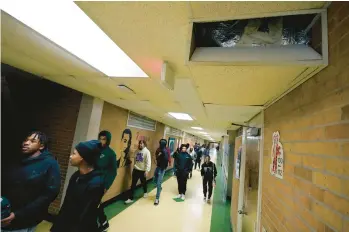  ?? ROGELIO V. SOLIS/AP ?? Jim Hill High School students walk past an open vent of the school’s HVAC system Jan. 12 in Jackson, Miss.