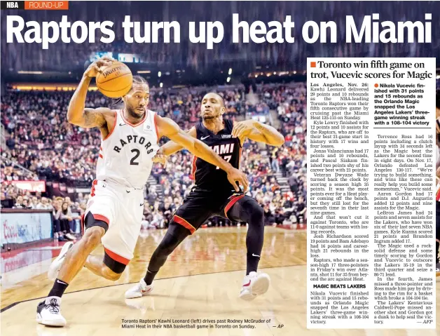  ?? — AP ?? Toronto Raptors’ Kawhi Leonard (left) drives past Rodney McGruder of Miami Heat in their NBA basketball game in Toronto on Sunday.