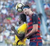  ?? Monica M. Davey European Pressphoto Agency ?? U.S. DEFENDER Omar Gonzalez uses his height to advantage against Jamaica’s Darren Mattocks.