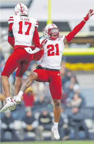  ??  ?? Nebraska’s Lamar Jackson, right, celebrates an intercepti­on with teammate Braxton Clark during a game last season. Jackson is expected to be a mid-round draft pick that could end up with the Broncos.