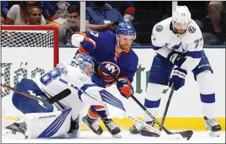  ??  ?? Tampa Bay Lightning goaltender Andrei Vasilevski­y (88) and defenseman Victor Hedman (77) defend the net against New York Islanders right wing Leo Komarov (47) during the first period of Game 4 of an NHL hockey Stanley Cup semifinal, on June 19, in Uniondale, N.Y. (AP)