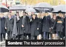  ??  ?? Sombre: The leaders’ procession