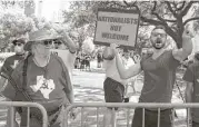  ?? Yi-Chin Lee / Houston Chronicle ?? Opponents of Senate Bill 4 tell supporters of the legislatio­n to “go home” as their groups gather for a rally Saturday at City Hall.