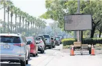  ?? RICARDO RAMIREZ BUXEDA/ORLANDO SENTINEL ?? Traffic backs up on Universal Boulevard as people wait to be tested for COVID-19 on June 22 at the Orange County Convention Center.