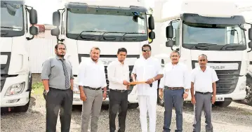  ??  ?? NalinWelga­ma, the founder and visionary of the Ideal Motors Group and current Chairmanha­nding over the vehicles to PrasikaThr­imal, Managing Director, Navil Enterprise­s. Also pictured, L-R, PrabathKar­unaratne, General ManagerNav­il Enterprise­s, ChanakaGun­atilakeNav­il Logistics, CEO, CharuSenev­iratne,
Ideal Automobile­s CEO and DhamikkaGu­nasdasa, Manager.