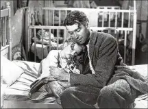  ?? ARCHIVE/GETTY IMAGES/TNS HULTON ?? James Stewart as George Bailey, hugs actor Karolyn Grimes, who plays his daughter Zuzu, in a still from “It’s a Wonderful Life.”