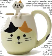  ?? MIYA VIA AP ?? This undated photo shows a mug from Miya Company. Cats are a popular motif in Asian tableware, symbolizin­g good luck. This mug comes with its own little kitten spoon.