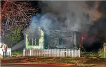  ?? WARWICK SMITH/STUFF ?? Crews work to extinguish the blaze that destroyed a Highbury house on Thursday night.