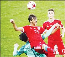  ??  ?? In this June 21, 2017 file photo Russia’s Aleksandr Erokhin (center top), challenges for the ball with Portugal’s Andre Gomes (left), as Russia’s Aleksandr Golovin looks at them during the Confederat­ions Cup Group A soccer match between Russia and...