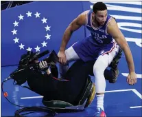  ?? MATT SLOCUM - THE ASSOCIATED PRESS ?? Sixers guard Ben Simmons, right, collides with a television photograph­er during the second half of Game 5 Wednesday night. The Sixers beat the Wizards in five games and will host Game 1against the Atlanta Hawks Sunday at Wells Fargo Center.