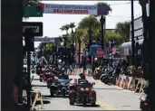  ?? SAM THOMAS — ORLANDO SENTINEL VIA AP ?? Bikers ride up and down Main Street in Daytona Beach, Fla., during the start of Bike Week on Friday.