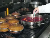  ?? Courtesy Dubai Municipali­ty ?? A Dubai Municipali­ty food inspector checks dishes being cooked at a restaurant.
