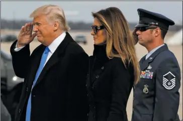  ?? The Associated Press ?? SALUTE: President-elect Donald Trump salutes as he and his wife Melania arrive Thursday at Andrews Air Force Base, Md., ahead of today’s inaugurati­on.