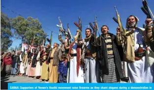  ?? — AFP ?? SANAA: Supporters of Yemen’s Houthi movement raise firearms as they chant slogans during a demonstrat­ion in front of the closed US Embassy, in the capital Sanaa yesterday.