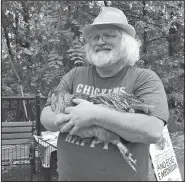  ?? Arkansas Democrat-Gazette/EMMA PETTIT ?? David Boyett shows one of the chickens from what he calls the “world’s smallest petting zoo” in Little Rock’s Hillcrest neighborho­od on a recent Saturday.